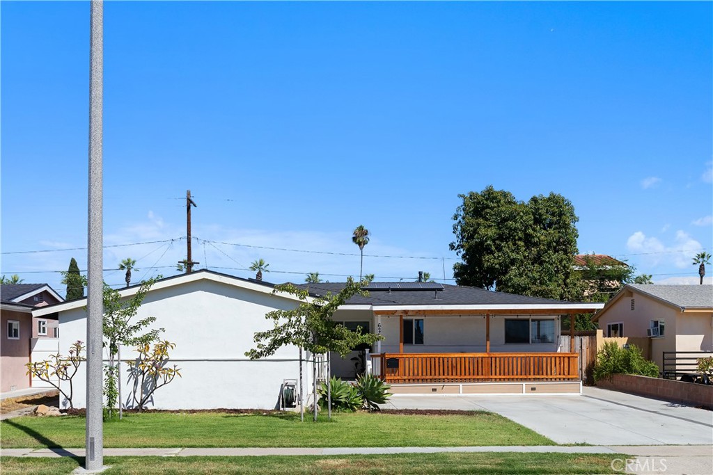 This Anaheim SINGLE STORY three bedroom , two bathroom home has been thoughtfully renovated, including fully purchased SOLAR panels, new kitchen counters, paint, fixtures, major appliances, lighting, and room decor. As you enter the front of the home, you are invited into the beautiful outdoor deck with beautiful shade cover as well! Inside the home the living room space that exudes style. The open floor plan adds warmth and charm to the space. New windows add natural light and energy efficiency, while insulation throughout ensures optimal comfort year-round. The stylish decor creates a cohesive and elevated atmosphere. The kitchen has been transformed with new custom designer contemporary finishes, beautiful cabinetry, and sleek appliances, perfect for cooking and entertaining. The bathrooms features custom new hardware, mirrors with integrated lighting. The bedrooms have been upgraded with fresh paint, and style offering a peaceful and stylish retreat. The living room exudes an open feel with custom big windows and glass doors to the backyard that adds warmth and charm to the space, making it perfect for both relaxing and entertaining. The garage is oversized with extra storage and laundry space. The spacious backyard provides a serene space for private enjoyment. This detached home offers the ultimate in comfort, style, and modern living. Welcome home!