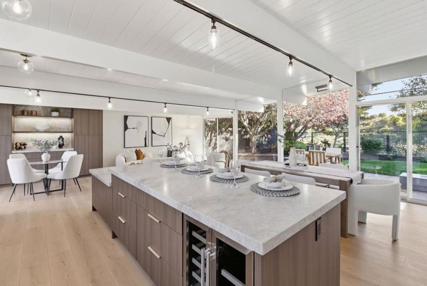 Discover modern California living in this beautifully remodeled Eichler-style home located in the highly sought-after San Mateo Highlands. This 4-bedroom, 2-bath residence blends iconic mid-century design with contemporary luxury, offering an inviting open-concept layout with abundant natural light. The heart of the home is the gourmet chefs kitchen, thoughtfully designed with a spacious island, premium new appliances, custom cabinetry, and sleek Taj Mahal Quartzite countertops, perfect for cooking, entertaining, and everyday living. The kitchen flows seamlessly into the expansive living and dining areas, creating a warm and functional space ideal for gatherings both large and small. Well-appointed bedrooms and tastefully updated bathrooms offer comfort and style, while the homes clean lines and indoor-outdoor connection reflect the timeless appeal of Eichler architecture. Situated in a desirable neighborhood known for its community feel and scenic surroundings, this property is just minutes from shopping, parks, and top-rated schools, with easy access to major freeways for convenient commuting. A rare opportunity to own a turnkey home in one of San Mateos most coveted enclaves.