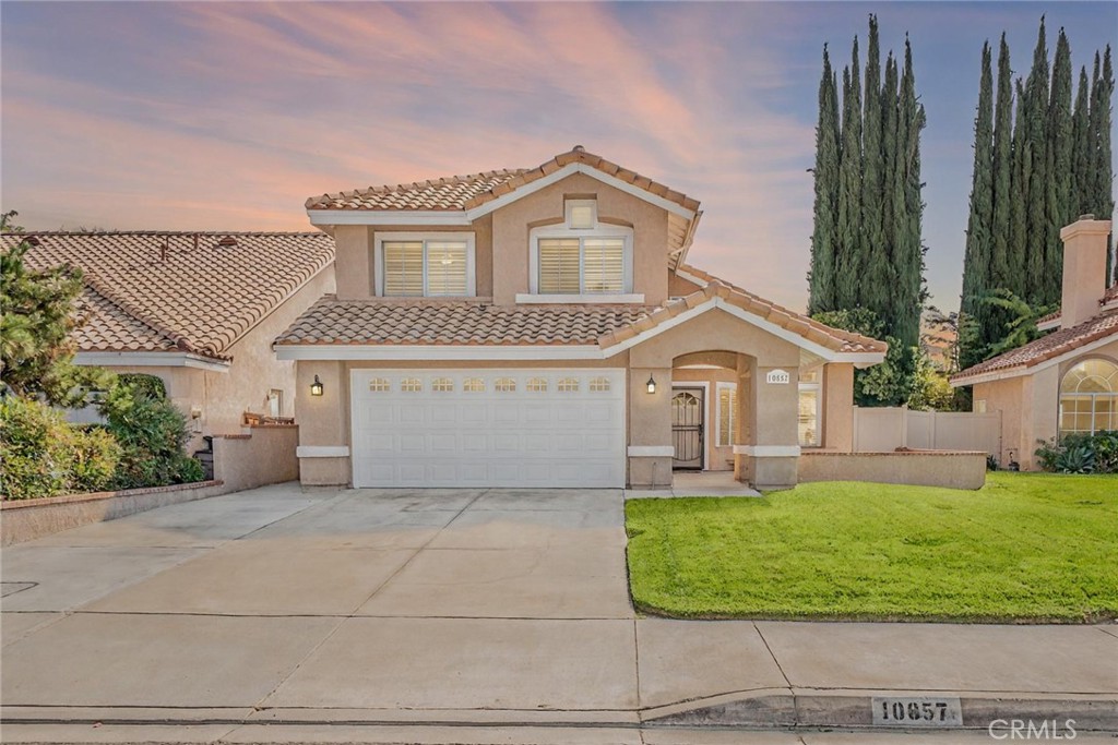 Welcome to this beautiful home in Rolling Hills, where you can enjoy the benefits of no HOA,and a low tax rate. This updated 4-bedroom, 3-bath residence is ideally situated next to prime amenities, providing a lifestyle filled with convenience. Imagine spending your weekends at Yucaipa Regional Park, biking to the community center, or making quick trips to Oak Glen for delicious fresh apple pie, all just minutes from your front door. The home is within walking distance of top-rated schools, including Parkview Middle School and Ridgeview Elementary, making it an ideal location for families.As you step inside, you'll be greeted by a stunning two-story entryway with high ceilings. The interior has been thoughtfully updated with newer floors, carpet, and fresh paint, all completed in 2022. The open and spacious formal living room and dining room combo is perfect for family gatherings. The cozy family room features a gas fireplace and flows seamlessly into a large kitchen equipped with newer appliances installed around 2 years ago and an island, providing ample cooking space for culinary enthusiasts.. Upstairs, the expansive primary suite is a true retreat, boasting dual sinks, a newer walk-in shower, a soaking tub, and a generous walk-in closet. This home also comes with several valuable features, including a two-year-old HVAC system and a roof that was re-papered with a double layer around 2021. Natural light floods the space through a skylight, and plantation shutters, newer lighting, and ceiling fans throughout add to the home's charm. You'll also find an inside laundry room, a spacious downstairs bedroom, and a bathroom that was remodeled in 2022. Outside, relax under a beautifully designed aluminum patio completed in 2023, featuring recessed lights and a ceiling fan, perfect for those warm summer days. With its prime location, thoughtful upgrades, and inviting layout, this Rolling Hills home is ready for its next chapter.