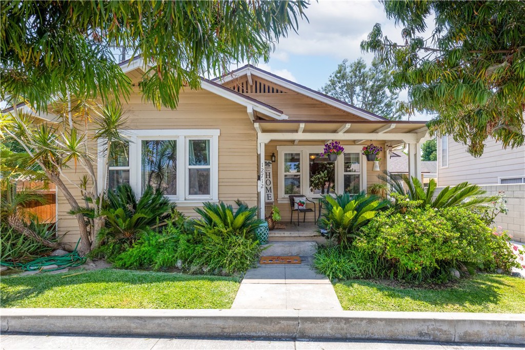 Step into a slice of history with this lovingly maintained 1922 Craftsman bungalow with Jr. ADU, brimming with character and warmth. From the welcoming covered front porch to the original woodwork and built-ins, every detail tells a story. The living room is bright and airy making it a cozy place to gather. The kitchen blends period charm with modern convenience, offering timeless details like farmhouse cabinetry and a cheerful laundry room that sits adjacent to the kitchen. Two comfortable and generously sized bedrooms and a beautifully restored bathroom provide an inviting retreat. This charming bungalow offers a newer roof, updated plumbing and double pane windows. Outside, the lush, landscaped is perfect for relaxing or entertaining. Located on a tree-lined street and walking distance from Uptown Whittier. This home is just minutes from local shops, cafés, and nightlife. Whether you're drawn to its rich history, distinctive architectural details, or cozy atmosphere, this Craftsman bungalow is ready to welcome you home.