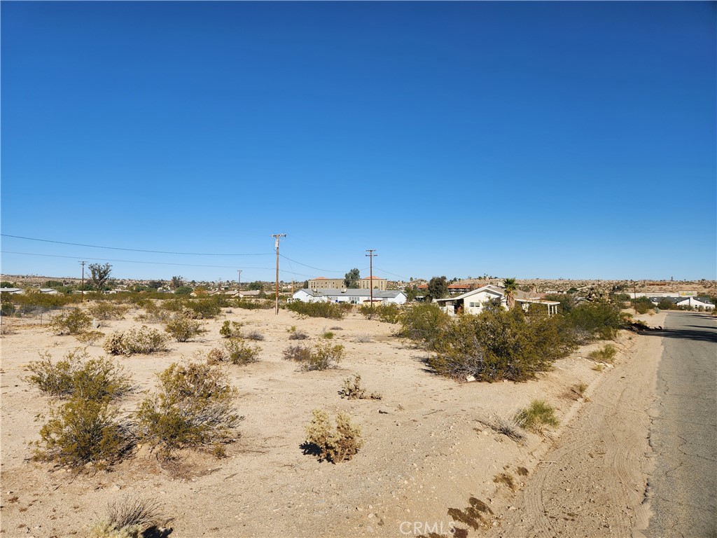 Residential Lot, 0.19 Acres (APN: 0616-111-04) GPS: 34.132086, -116.07748 This residential lot is located in Twentynine Palms, CA. Twentynine Palms has zoned this property Residential (RS-4). The city has zoned the property for single family homes, with a maximum of 4 units per acre. Imagine building your desert getaway and waking up to bright desert sunrises, panoramic views of rugged mountains, or dark starry nights. Overhead electricity is on site. The Twentynine Palms Water District services the area and provides water in the street. Residents have septic tanks for their sewer needs. Living in Joshua Tree, CA, offers a unique blend of natural beauty and laid-back desert living. Endless opportunities for outdoor adventures are a short drive away in Joshua Tree National Park. There's always something exciting to explore. Plus, the tight-knit community fosters a sense of belonging, with local shops, art galleries, and events showcasing the area's vibrant culture. Whether you're seeking tranquility or adventure, Joshua Tree welcomes you with open arms. This property does not yet have an address. While the boundary lines on the map offer a glimpse, they are only approximate. A Buyer should verify boundaries, zoning and utilities, ensuring every aspect aligns with their vision for the property.