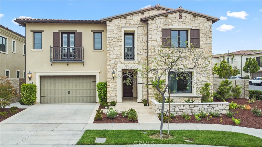 The highly sought-after Solano Collection by Toll Brothers is located in the prestigious 24-hour guard-gated community of Altair. Nestled on a premium corner lot, this home features 5 spacious bedrooms, 5.5 bathrooms, and soaring 20ft ceilings in the great room, complemented by a 24" multi-panel stacking door that seamlessly blends indoor and outdoor living. Designed to model-home standards, the property boasts tile flooring throughout the hall, living room, dining room, and kitchen, with elegant wood flooring in all bedrooms, the loft, and on staircases. The gourmet kitchen is outfitted with top-of-the-line WOLF appliances, a built-in 60-inch SUB-ZERO refrigerator, upgraded cabinetry, a premium sink, and Caesarstone countertops and island. A 15-inch multi-panel stacking door enhances the kitchen’s open layout. The second-floor loft offers versatile space for various uses, while the luxurious master suite features coffered ceilings, a spacious walk-in closet, and a serene retreat. The master bathroom includes dual vanities, a large shower with a seating area, and a soaking tub for ultimate relaxation. Resort-style amenities within the community include a private clubhouse, multiple swimming pools, tennis courts, outdoor fireplaces, and BBQ areas. The home is conveniently located near shopping, dining, parks, sports fields, and award-winning Irvine Unified schools while having easy access to major destinations like the Great Park, Irvine Spectrum, Fashion Island, John Wayne Airport, and highways 405, 5, 133, and 241.