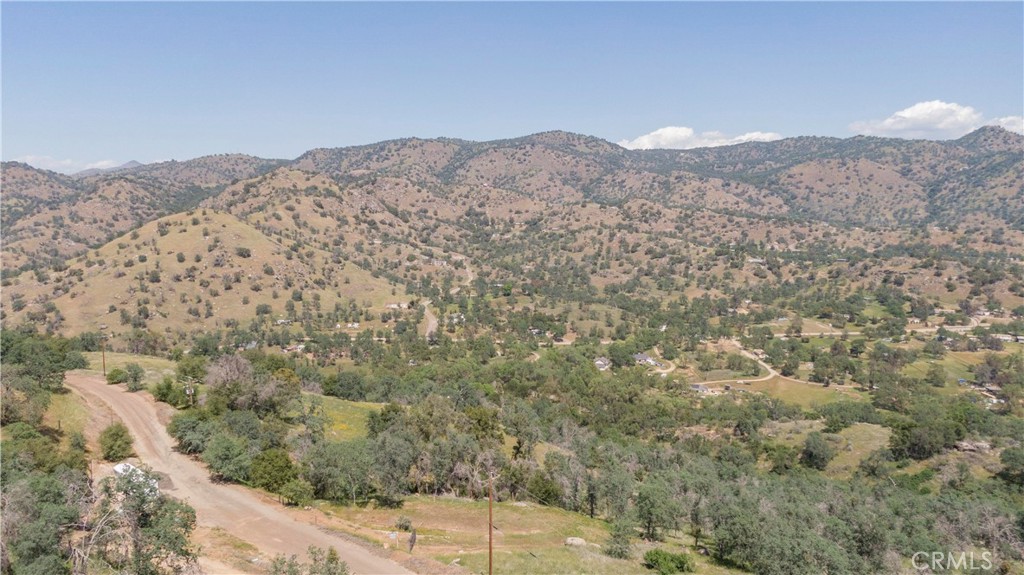 Private 4.75+- acre lot with stunning mountain views on a low traffic road. This property is studded with mature oak trees and unique rock outcroppings. Improvements include a driveway, recently enlarged building pad, retaining wall and septic system, and as per seller, access to water.
Beyond the current leveled area, the property meanders down to a large open and level area that would also make an excellent homesite, shop area,
orchard... The location around the corner from the Country Store & about 15 minutes to HWY 180 or Orange Cove. Great water in the area. Come see it while it lasts!