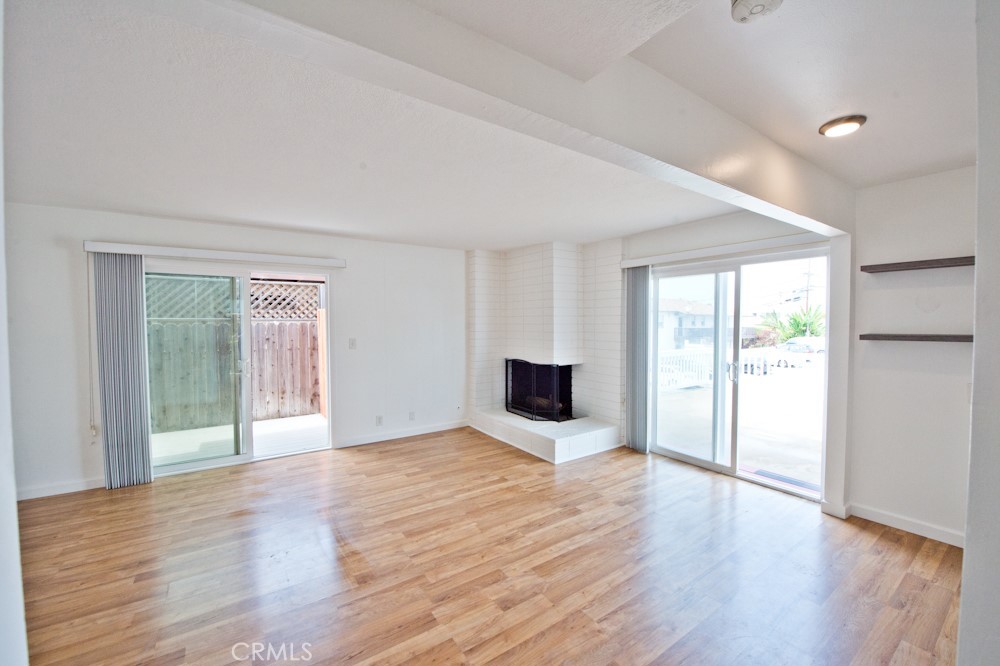 Remodeled two bedroom, 1.5 bath townhome offering ocean views from oversized front deck and primary bedroom with its own private balcony. Living room with fireplace , sliding glass doors leading out to private courtyard and another set leading out to oversized front deck with ocean views. Remodeled kitchen with Retro-oven, four burner gas cook top, stainless steel microwave, fridge, two tone cabinetry and floating shelves. Downstairs is also updated powder room. Upstairs is primary bedroom with large walk-in closet, ocean views and private balcony. Secondary bedroom with mirror wardrobe doors. Remodeled bathroom upstairs. Brand new furnace. Engineered flooring throughout. No carpet. One detached carport. On site community laundry room for the the 3 units in the building. Nearby shops, restaurants, beaches. This is a prime location.