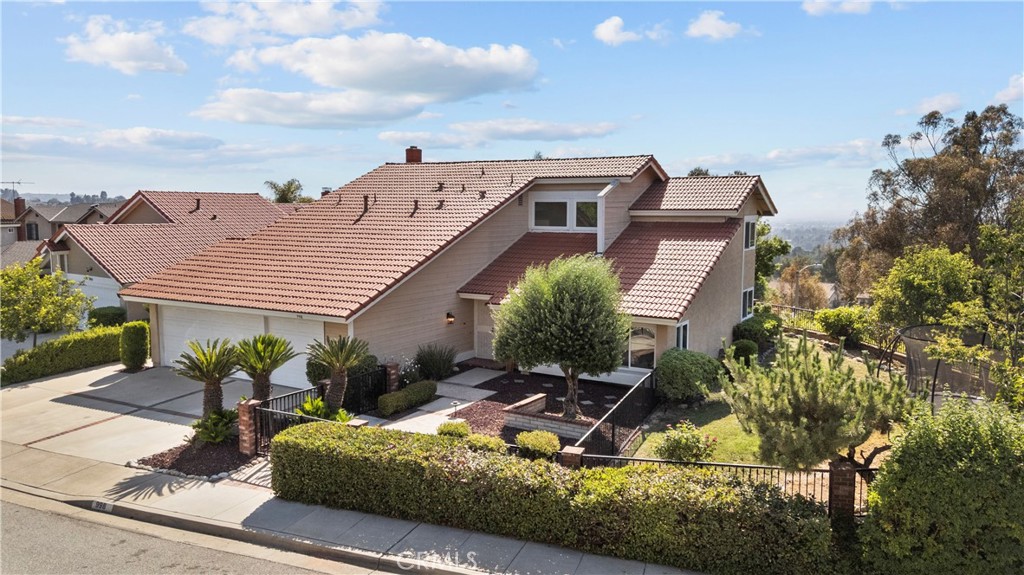 BREATHTAKING CITY LIGHTS & MOUNTAIN VIEW HOME IN VIA VERDE. Introducing a rare opportunity to own a spectacular view home located in San Dimas’ highly sought-after Via Verde neighborhood. Perched near the top of the community on one of its most premier streets, this beautifully upgraded residence showcases panoramic views of the city lights and San Gabriel Mountains—an offering seldom available. Set on nearly a quarter-acre lot, the home offers an expansive backyard ideal for entertaining, with plenty of space to add a pool. The traditional two-story layout is enhanced with luxury laminate wood flooring, soaring vaulted ceilings, and a fully remodeled downstairs guest bedroom and bathroom—perfect for extended family or guests. Enter through the grand foyer into an elegant formal living room that flows seamlessly into the spacious formal dining room, both of which capture the home's stunning mountain views. The large kitchen features ample cabinetry, stainless steel appliances, a picture window framing endless city light views, and breakfast bar seating. Just off the kitchen is the inviting family room, complete with a wet bar and a floor-to-ceiling gas fireplace. Natural light floods the home thanks to cathedral ceilings, newer dual-pane windows, and expansive second-story windows. Upstairs you'll find four generously sized bedrooms, including an oversized primary suite featuring vaulted ceilings, three large closets, and panoramic views. The recently remodeled primary bathroom offers a spa-like retreat, complemented by a second beautifully updated full bathroom with a custom glass-enclosed shower. Step outside to a resort-style backyard perfect for entertaining, complete with a custom Alumiwood patio cover, dual seating areas, a built-in BBQ island with refrigerator, ceiling fans, outdoor TV setup, mood lighting, and a variety of fruit trees including lemon, orange, plum, and apple. Additional highlights include a spacious three-car garage with vaulted ceilings and potential for a loft or storage space, plus a brand-new central A/C system. Ideally located just minutes from Via Verde Country Club, Bonelli Park, Raging Waters, San Dimas High School, and the historic downtown district, this is truly one of Via Verde’s most exceptional homes.