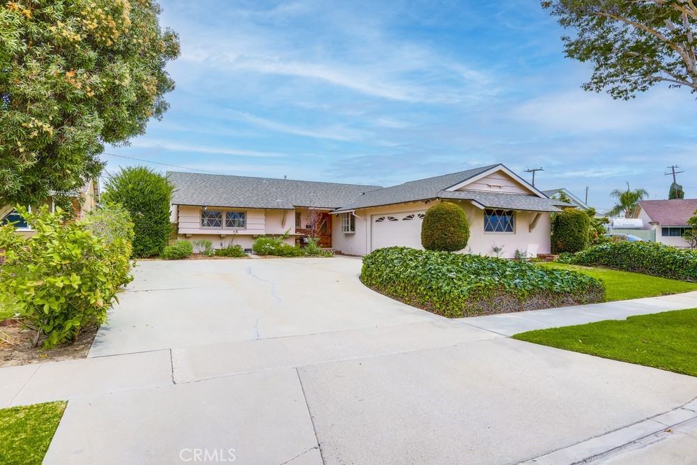 Welcome to this move-in condition home nestled in the interior of a quiet cul-de-sac. Great Curb appeal with a new roof and exterior paint. The home has original refinished hardwood flooring and a freshly painted interior. The kitchen features black cabinetry, tiled counters, stainless steel appliances, and a built-in laundry room. The dining area, located adjacent to the kitchen and living room, features a cozy fireplace and is open to the adjoining family room, which boasts an additional fireplace and a high-beamed, open ceiling. Step out into the private backyard and view the sparkling redone swimming pool and relaxing yard.