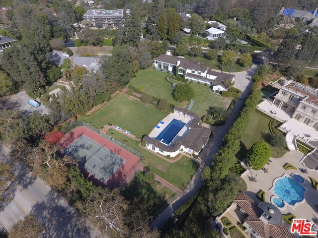 REDUCED! New price & unparalleled value! A remarkable opportunity in prestigious Holmby Hills on one of the most coveted streets in the city! This gorgeous 1930's Colonial style home sits on approx. 1.66 acres of beautifully manicured grounds. 355 S. Mapleton boasts an expansive street to street lot w/ sprawling lawns, gardens, a pool & pool house pavilion, & a full size N/S tennis court. This rare offering presents an incomparable opportunity to remodel or redevelop to build your dream estate in a location that epitomizes luxury & sophistication. Make your home amongst world renowned estates such as the Playboy Mansion, the Spelling Manor & others. With an entrance off of Mapleton, the current 6bd, 5ba home is overflowing with charm. The grand foyer sets the tone for the rest of the property with hdwd floors, beautiful detailing, & a dramatic staircase. The current home also boasts a rich history with ties to the motion picture industry. Seize the moment & the endless possibilities!