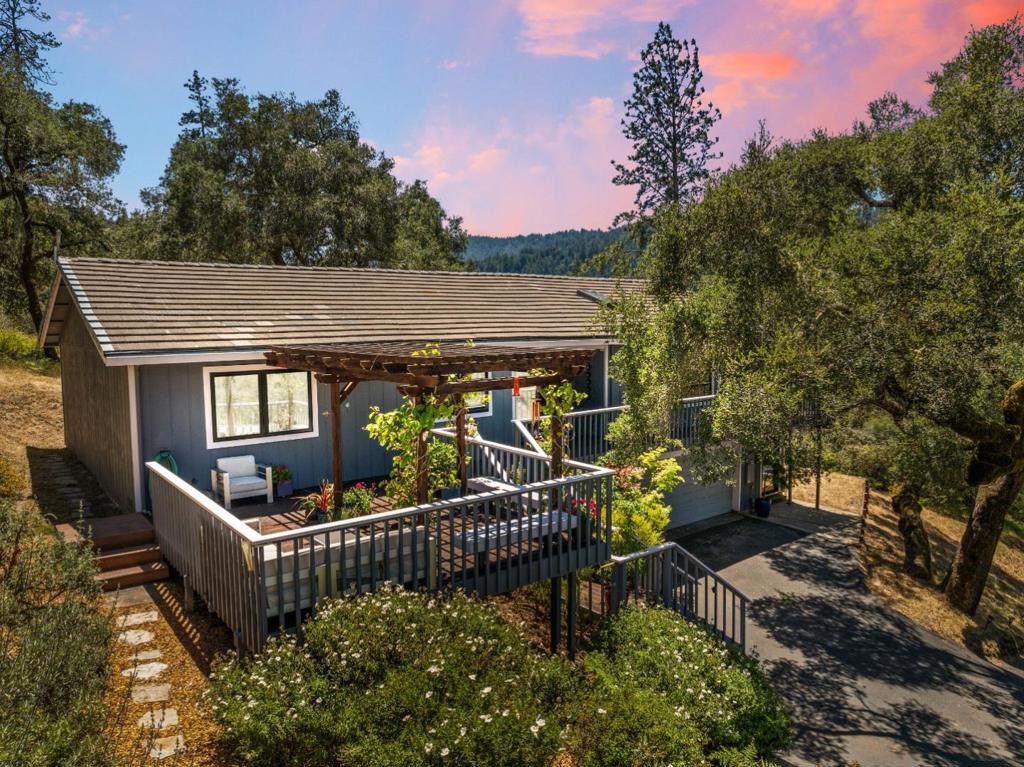 Set on two beautiful acres in one of California's most unique ecosystems, 2203 Quail Hollow Rd is a private retreat in a highly sought-after Ben Lomond neighborhood. Gorgeous landscaping featuring Japanese maple, red manzanita, and oak trees gives the home standout curb appeal. Inside, soaring ceilings and floor-to-ceiling windows fill the space with light and stunning views. The kitchen is a dream for any chef, complete with Calacatta marble countertops, Fisher & Paykel appliances and a Bertazzoni hood. Venture outside to a spacious patio perfect for evening relaxation under the stars. The primary suite offers ample closet space and a spa-like soaking tub. Additional highlights include Andersen and custom windows, Acacia, Brazilian Teak, and Maple flooring, plus Italian and Japanese tile in the bathrooms. A lower-level flex space with a half bath provides a great option for a home office, studio, or library. Close to world-class hiking, biking, and just 20 minutes to Santa Cruz.