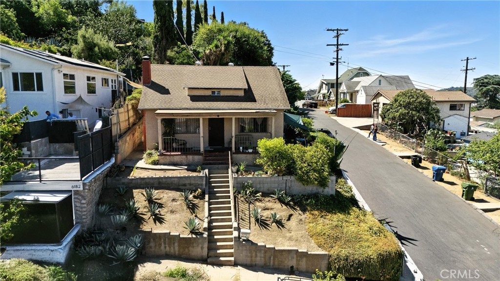 Highland Park Residence features 2 bedrooms, a loft and 1.5 bathrooms, complemented by a detached 2-Car Garage that includes a Studio/Guest House above approximately 450 sq ft. of living space complete with a full kitchen, bathroom and closet and a Pool with Epic Views at properties top tier! Situated on a gentle upslope in the desirable Garvanza area of Highland Park , this property boast Panoramic Views through out ,approximately 1,130 sq ft of living space at main house , a newer roof , a wood burning fireplace and a large kitchen that opens up to the formal dining area making it a perfect canvass for the buyer looking to break into this Higly sought after neighborhood with the potential to collect income from the back house or an Investor looking for a high rate of return. Property will be delivered Vacant and is located minutes away from bustling York blvd and Figueroa st. corridors with quick access to the metro gold line ,110 and 5 freeways making the commute to Downtown La and Pasadena a breeze. Nearby Parks and hiking trails offer nature lovers a perfect balance of city living and outdoor space.