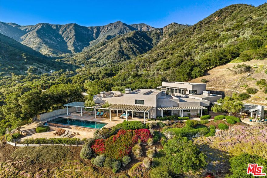Located in a tranquil corner of Toro Canyon with sweeping views, just moments from Montecito and Summerland, this extraordinary 9-acre estate offers a rare blend of privacy, architectural pedigree, and natural beauty. A newly reimagined sanctuary, the property features a striking main residence and a charming guesthouse, thoughtfully placed amid lush landscaping and expansive outdoor living areas. Completed in 2025, the main residence reflects a curated fusion of Modernist and Japandi influences, all brought to life under the vision of renowned architect Robert ''Bob'' Easton. Inside, calm sophistication reigns. The spacious living room is anchored by a dramatic 17-foot slat-vaulted, open-beam ceiling, a sculptural fireplace, and sliding doors opening to a pergola-covered terrace.Portuguese limestone floors and slate-gray plaster walls set a serene tone throughout the main level. The gourmet kitchen is appointed with sleek black granite countertops, custom cabinetry, and top-tier stainless appliances. Nearby, an approximately 500-bottle temperature-controlled wine room offers both convenience and luxury. Both the primary and secondary bedrooms feature spa-inspired ensuite baths, generous closets, and access to multiple pergola-shaded terraces-each designed to invite indoor-outdoor living at its finest. Outdoor highlights include a sparkling infinity-edge pool, in-ground spa, built-in Wolf BBQ, and an alfresco dining area-all perfectly suited for entertaining or quiet repose. Enhanced by advanced home automation and fire prevention systems, this exceptional estate is where modern serenity meets timeless California style.