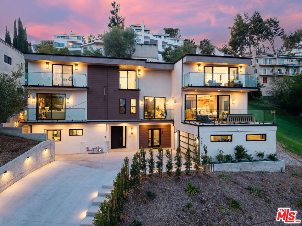Come experience this Woodland Hills redefined, gated masterpiece of modern elegance, where luxury meets breathtaking views. The 3840 sf Solar home is complete with 4 bedrooms - 3 Ensuites - PLUS attached ADU with kitchen, bath, own HVAC and separate entrance and complemented with 5.5 baths, with exquisite details throughout. Located South of the Boulevard, this newly built home with solar panels offers the perfect balance of style, space, and versatility, epitomizing South of the Boulevard living at its finest. From the moment you arrive, the panoramic views will captivate you whether it's in the dining room that also looks out at the pool, spa, and BBQ or the extra-large balcony off the living room, the views stretch for miles offering a serene backdrop. A multitude of windows flood the interior with natural light and views seamlessly connecting the home to its scenic surroundings.Detailed with Designer touches keeping both function and beauty in mind, this home features a spacious trilevel floor plan perfect for entertaining and everyday living. And with the added bonus of an attached 540 sf ADU with it's own full bath and kitchen, the possibilities are endless whether it's for guests, a home office, or rental income. Unwind in the private backyard surrounded by an open patio complete with BBQ and kitchen. More than just a home, this is a statement property a rare find in one of the most desirable neighborhoods, offering luxury and endless potential. Don't miss the opportunity to call this Woodland Hills gem your own. Come be a part of this vibrant and thriving city where the LA Rams call home. Below Market Financing Available.