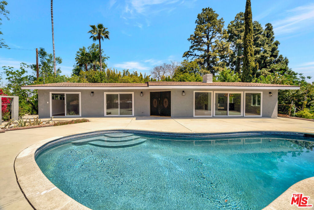 Located at the top of Studio City is this 4-bedroom & 3-bathroom home. Totally private & gated, the property provides a spacious home w/ amazing canyon & hilltop views. A long driveway leads you to the property that comes with a large pool & yard. The main house includes plenty of natural light & the open floor plan, with a master suite plus guest suites, another bedroom & bathroom, a spacious kitchen with a small dining area, and a built-in wet bar. The property includes a separate fully independent 1 bedroom & 1 bathroom guest house w/ kitchen and its own laundry. The home was recently renovated with updated bathrooms & plenty of closet space. 2-car garage plus additional driveway space.