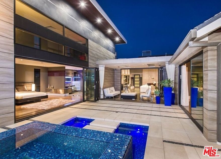 Beyond the gated driveway, resides a custom built, 4,200 sqft modern home located in the heart of Brentwood. Furnished by Modani, grand skylights that compliment the vaulted ceilings, lead to the bi-fold glass walls that effortlessly unite the living space to the expansive exterior. The serene backyard includes, heated pool/spa, outdoor shower, kitchen and cabana, loaded with all entertainment necessities. Sitting on approx. 14,113 sqft lot, this impeccable home offers 4 master suit bedrooms with bi-fold glass walls, 5 bathrooms, sophisticated open gourmet kitchen and last but not least, its unique lighting throughout the interior and exterior. This home is nothing short of lavish, brought to life by renown architect and designer.