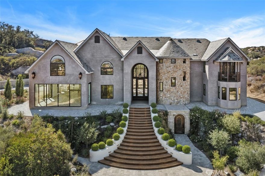 Welcome home to this Impressive Custom built estate with Stunning Million $$$ Views! Situated on 15.59 pristine acres within the prestigious La Cresta Highlands area.  Imagine being King of the hill with the Cleveland National Forest just out you backyard! California's Best Kept Secret! A place where dreams come true! Featuring approximately 7000 square feet of living space with two separate stair cases, 4 bedrooms, 4 baths, formal living & dining, Chef's kitchen with massive pantry, office, theatre room, primary suite with vaulted ceiling, huge walk-in closet & partially finished luxury primary bath. The gourmet Chef's kitchen is designed for your personal choice of custom cabinetry, counter tops, faucet's and fixture's. It is equipped with Viking stainless steel appliances including dual oversized refrigerator's, oversized freezer, 8 burner cook range w/ two ovens, hood, microwave, dishwasher & trash compactor. Other features include exquisite custom steel doors, wrought iron railings, floor to ceiling windows, upstairs balcony, set up for future elevator, Lorex security system w/ 8 camera's, expansive laundry room with sink and loads of cabinets, huge walk-in attic storage, upstairs reading nook, interior fire sprinklers, propane line in formal living room for future fireplace, water line in pantry & above cook range in kitchen for future pot filler, high-end Vermont Slate roof, 22 foot ceilings, wired for data, sound & Cat 6, four-4 ton AC units,70 PSI pressure pump, 5000 gallon water storage tank, 4" & 1.5" outlets w/ fire hoses & great area's for executive pool, outdoor kitchen, guest home, barn, tennis courts, groves or anything else ones heart may desire! The estate is partially fenced with an exceptional estate gate entry! The property can also be sub-divided into 3 five acre parcels. Please see the supplement sheet for a list of items that need to be completed to obtain the certificate of occupancy. La Cresta Highlands Life offers exceptional opportunity for country living at its finest with twinkling star filled skies, scenic open space, private trail systems, Santa Rosa Plateau Ecological Reserve & lovely community events! Located within minutes from all modern conveniences, award winning schools, restaurants, premier golf courses, shopping malls, hospitals, world renowned wineries, resorts & I-15 freeway. Less than 1.5 hours from LA, San Diego, Palm Springs, Beaches, Mountains & Amazing Theme Parks. The epitome of peace & tranquility!