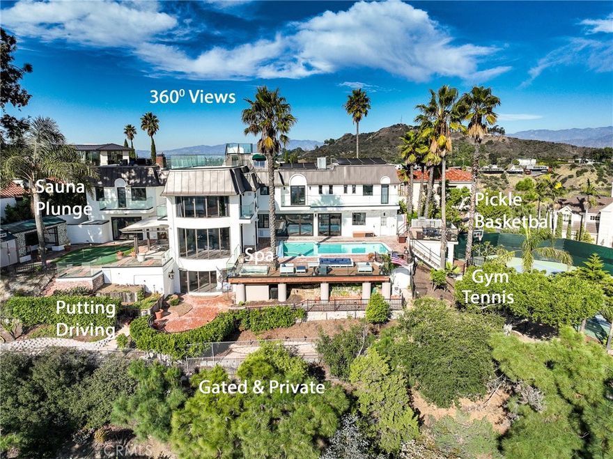 Resort/Spa Hollywood Hills Estate with breathtaking views from the Hollywood Sign to downtown to the ocean. Natural light beams through the stunning panoramic windows to an open floorplan, complete with a chef’s kitchen, dining room, family room, grand living room, 3 wet bars & more. Dine under the stars with an outdoor kitchen and dining deck. Located in the trendy enclave of Mt. Olympus, this large, gated, smart-home mansion features large gathering areas and private gardens with premium sound, security, and modern conveniences. Enjoy the indoor-outdoor California lifestyle with multi-story decks, a large pool, and a multi-sport court for tennis, pickleball & basketball. Relax in the sunken hot tub. Play on the putting green and ping pong table. Exercise in the professional gym overlooking the Hollywood sign. Get the health benefits of the Michael Phelps Sweaty-GOAT infrared Sauna and cold plunge. The romantic primary bedroom features a soaking tub for two by the light of a fireplace and four balconies overlooking LA LA Land. This primary bedroom features explosive views, a big movie screen, and huge closets. A second primary BR features a fireplace, en-suite bathroom with a spa tub & a balcony with sweeping views. Upstairs, three more bedrooms offer views, balconies, and 2 more bathrooms. The first floor lives for entertaining & playing. The open floorplan flows an intimate sitting area, a dining table for 12, and a chef’s kitchen. The large wet bar opens to the pool deck & living room, all with a world-class sound system. The media/gaming room features a large screen dedicated to gaming and a huge silver screen for movies and TV. A club sound system makes this perfect for dancing. There’s also a security guard/maid’s room (8th bedroom). The library and media room feature queen-sized Murphy beds. This architectural gem combines Hollywood Regency (think Chateau Marmont) with modern finishes, glass walls, and smart home sound & lighting. On a cul-de-sac with armed neighborhood security patrol, this gated estate offers easy access to the Westside, Studios, and the Valley. The circular brick driveway parks 6-7 vehicles. Several start-ups were launched in home office with a separate entrance. Renovated in 2022.