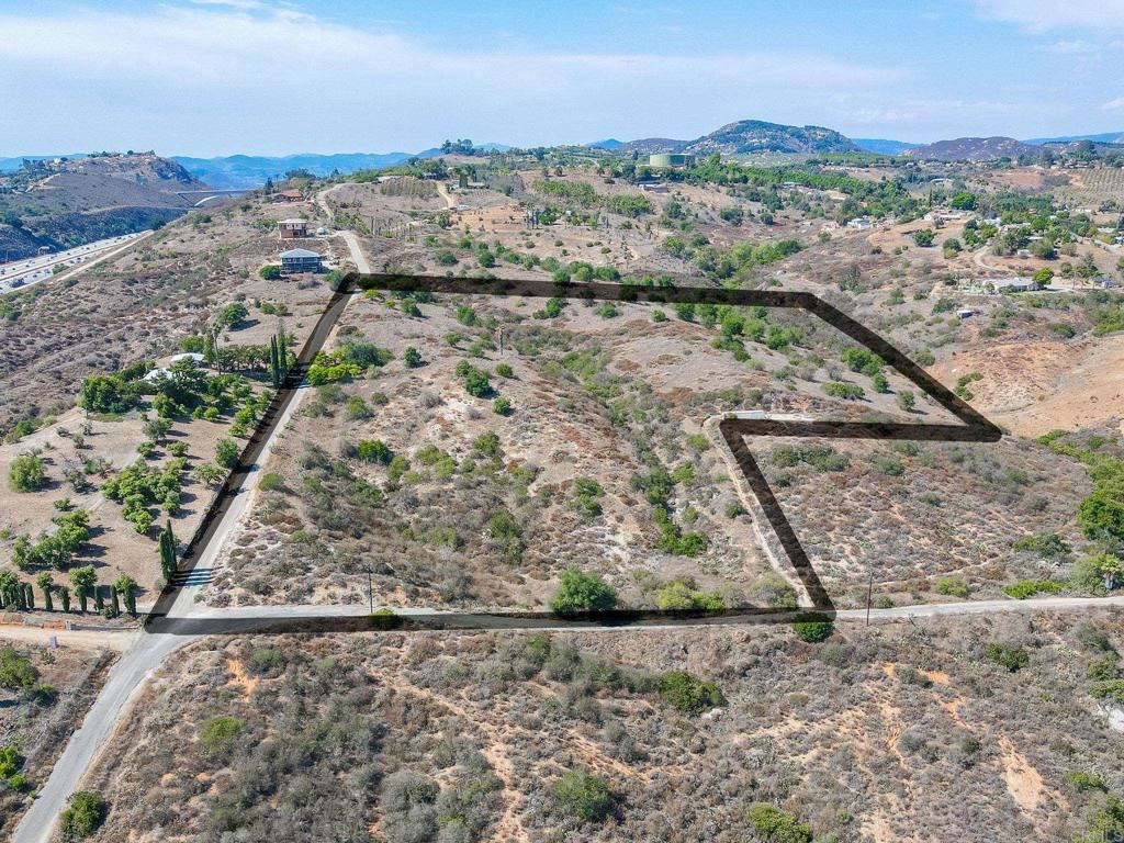 Dream, Design, & Build on 7.72 Scenic Acres! Imagine building your custom home on this peaceful, semi-rural property once thriving as an avocado grove—now ready for your vision. This expansive 7.72-acre lot offers breathtaking views, tranquility, & endless potential. With a Valley Center water meter already installed & nearby utility pole access, the essentials are in place to get started. Ideally located just minutes from I-15, shopping, dining, and schools—plus new home developments underway nearby—this location combines convenience with privacy. Zoned agriculture/semi-rural residential, the lot is perfect for your private retreat, hobby farm, or estate dream home. Don’t miss this opportunity to turn this beautiful land into your own slice of paradise in the Escondido/Bonsall area.