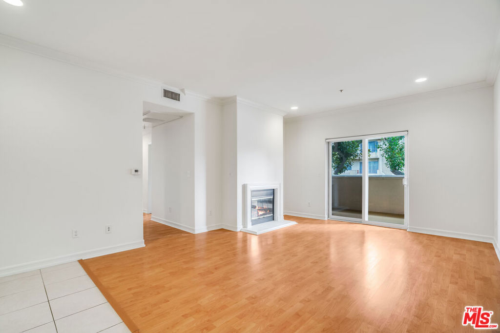 Prime location! This bright, immaculate first-floor apartment (one level above ground) is just minutes from UCLA and the freeway. Enjoy high ceilings, stainless steel appliances, and a huge, usable west-facing balcony. The primary suite features a large walk-in closet and en-suite bathroom. For your convenience, the unit includes a washer/dryer and 2 parking spaces. This secured-access building has an on-site gym and EV charging. Water and trash are paid by the landlord! (650+ credit & 2.5x income required).