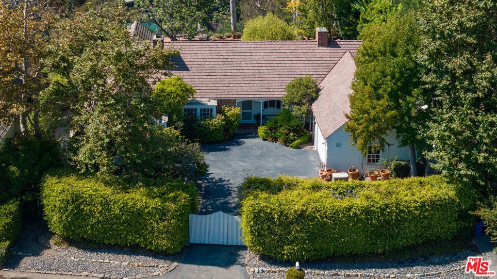 Introducing a rare gem in the heart of the Pacific Palisades Riviera, one of the most sought-after enclaves in Los Angeles where timeless elegance meets coastal charm. This exceptional gated property is set on the rim side of Amalfi Drive and is available for the first time in decades offering the perfect blend of privacy and convenience. With its peaceful position on the rim, the property enjoys a sense of seclusion while also offering breathtaking canyon and mountain views, creating a perfect blend of nature and luxury. Set on a generous lot with expansive outdoor space including a swimmer's pool, grassy yard, stone patios, and sweeping westerly views, the existing Gerard Colcord AIA single-level home features a classic design with endless potential to renovate, expand, or create your dream estate. The original Colcord design features signature elements such as wood-beamed ceilings, massive stone fireplaces, and inviting living spaces that exude charm and character. Mature landscaping surrounds the home, providing a tranquil oasis just moments from the vibrant Palisades Village, local parks, and stunning coastline.Whether you're drawn by the allure of its historic charm or the possibility to envision something new, this is an unparalleled chance to own a piece of Pacific Palisades history. and an extraordinary opportunity to secure a legacy property in one of the most sought-after neighborhoods of Los Angeles. Rarely does a property of this caliber become available. This is an unparalleled offering for discerning buyers who value architectural integrity, generous land, and the best of Pacific Palisades living. This Amalfi Drive estate promises to be a timeless sanctuary for generations to come