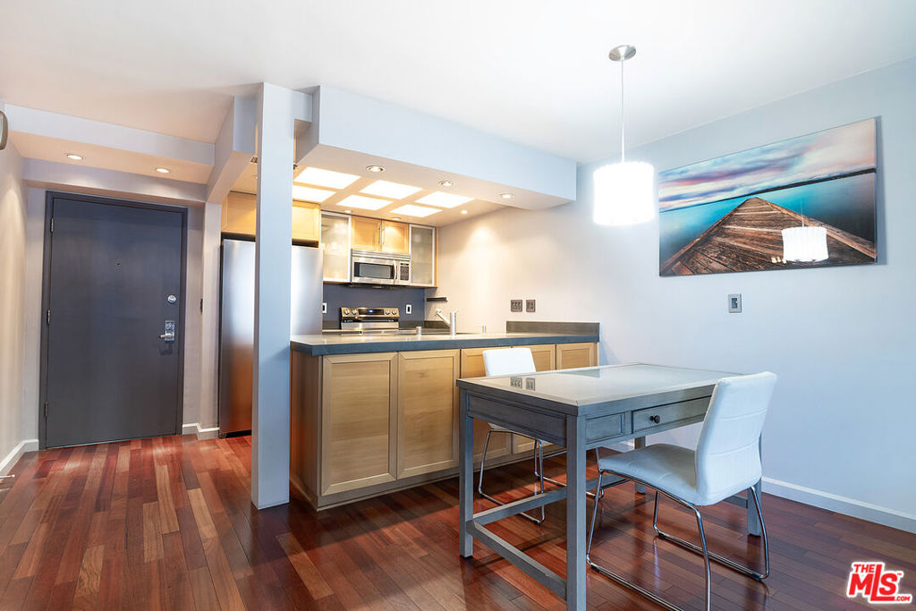 Top-floor south-facing 1-bedroom, 1-bathroom condo on tree-lined Kings Road in the heart of West Hollywood! The kitchen features stainless steel appliances, concrete countertops, recessed lighting, and generous cabinet space. Enjoy an open-concept dining and living area with a cozy gas fireplace and sliding glass doors that lead to a private patio. The spacious primary bedroom boasts a walk-in closet and direct access to the patio. The updated bathroom includes granite countertops and a tub/shower combo. Additional highlights include hardwood floors throughout and central AC and heat. Community amenities include secure garage parking, a fitness center, two spas, laundry facilities on each floor, and a rooftop sun deck with BBQ area and stunning mountain and treetop views. Just steps from West Hollywood's top shops, restaurants, and nightlife!