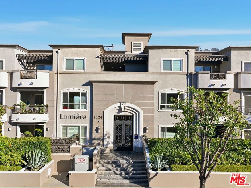 This stunning corner penthouse combines elegance, comfort, and convenience in one of Studio City's most coveted locations. Perched on the top floor, the residence welcomes you with a formal entryway that opens into an expansive, light-filled living space featuring recessed lighting, custom built-ins, and a cozy corner fireplace. The adjoining dining area flows seamlessly onto a private balcony--perfect for taking in neighborhood and city views. The gourmet kitchen is both stylish and functional, appointed with sleek stainless-steel appliances, pristine stone countertops, and a convenient breakfast bar ideal for casual meals or entertaining guests. A rare third bathroom elevates the home's versatility and luxury. The primary suite is a true sanctuary, offering serene treetop views, a massive walk-in closet, and its own private balcony. The spa-inspired en-suite bathroom is equipped with dual vanities, an oversized soaking tub, and a glass-enclosed shower. The spacious second bedroom enjoys abundant natural light and generous closet space, making it an ideal guest retreat or home office. Additional features include in-unit laundry, hardwood floors throughout the main living areas, plush carpeting in the bedrooms, and recessed lighting in every room. The home also comes with two individual parking spaces plus ample guest parking. Lumiere is an impeccably maintained boutique building centered around a beautifully landscaped courtyard with a fountain and outdoor fireplace. Residents also have access to a fully equipped first-floor gym. Located in an exceptionally walkable neighborhood, the home is just two blocks from Beeman Park and close to top restaurants, shops, and entertainment. This is a rare opportunity to enjoy luxurious penthouse living in one of Studio City's most sought-after buildings.