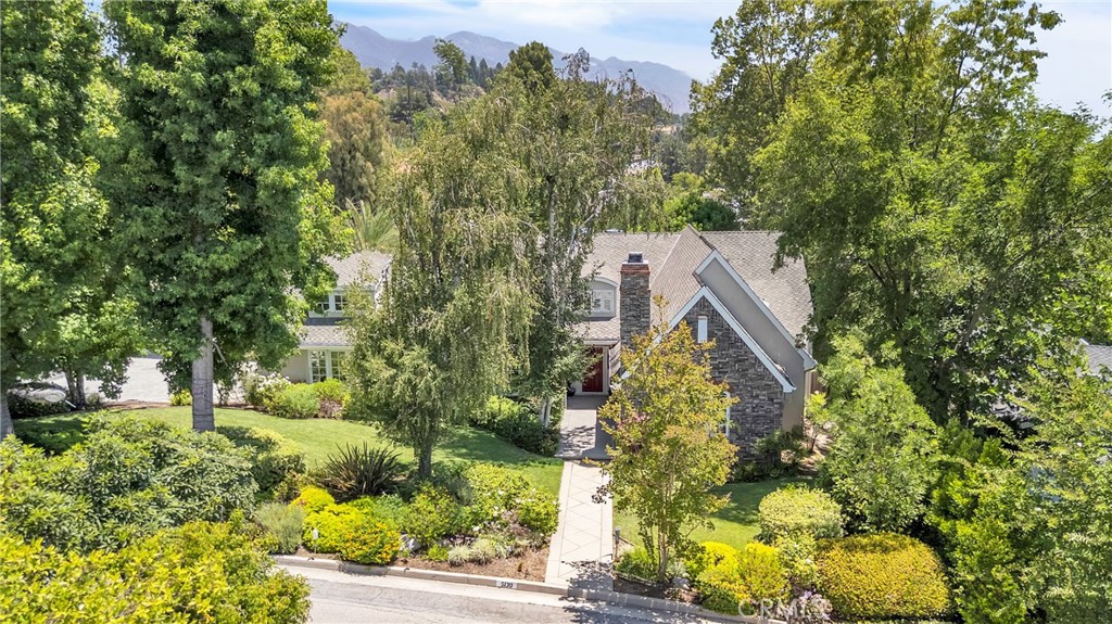 Welcome to 5130 Hayman Avenue—a refined single-level residence situated on a quiet cul-de-sac in one of La Cañada Flintridge’s most desirable neighborhoods. This beautifully upgraded 4-bedroom, 4-bathroom home offers approximately 3,693 sq ft of well-appointed living space on a lush 16,407 sq ft lot, blending classic charm with contemporary enhancements.
Inside, the home features vaulted ceilings, rich wood floors, and a seamless open-concept layout ideal for both entertaining and everyday living. The formal living and dining rooms each offer a cozy fireplace, while a custom wet bar and the temperature-controlled wine cellar make hosting effortless.
At the heart of the home is a spacious kitchen and family room that open directly to a resort-style backyard oasis. New electric pergola with motorized adjustable louvers provide flexible shade and comfort throughout the day, creating an ideal setting for outdoor lounging or dining. Take a dip in the sparkling pool then refresh in the separate ¾ bathroom located just steps away, dedicated to poolside guests.
The luxurious primary suite is a peaceful retreat featuring its own fireplace, walk-in closet, and spa-style bath. Three additional bedrooms and upgraded bathrooms provide ample comfort for family or guests. A detached studio offers endless possibilities as a home office, fitness room, or creative space.
Located within the highly acclaimed La Cañada Unified School District and close to parks, hiking trails, and local shops, this home delivers luxury living with everyday convenience.