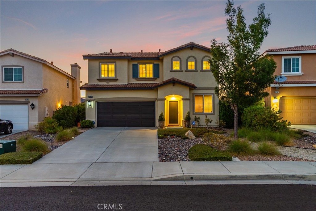 **Welcome to this beautifully upgraded newer construction home, perfectly tucked away on a peaceful cul-de-sac in the highly sought-after Ana Verde community.** Featuring **3 spacious bedrooms, 2.5 bathrooms, a versatile loft, and a private putting green**, this residence offers **fantastic mountain views** and a thoughtfully designed floor plan ideal for both everyday living and entertaining.
The **gourmet kitchen** impresses with abundant cabinetry, a large center island with breakfast bar, **gorgeous granite countertops**, stainless steel appliances, and a striking **Italian chevron tile backsplash**. The open family room is anchored by a **cozy fireplace**, **built-in library cabinetry**, and custom wiring for your entertainment setup.
Upstairs, the **primary suite** is a true retreat with a **coffered ceiling**, generous walk-in closet, and a **spa-inspired bath** featuring dual sinks, a soaking tub, and a separate shower. Throughout the home, you’ll find **custom two-tone paint, plantation shutters, designer window treatments, upgraded lighting** (LED fixtures, chandeliers, pendants, and exterior lights), and **wide-plank luxury vinyl flooring** in key living areas.
Step outside to a **professionally landscaped backyard** created for low maintenance and enjoyment. It includes **colored concrete patios, irrigation system, lush plantings, Mediterranean palm, roses, and a putting green**—all while you relax and take in the **breathtaking mountain views**. A **finished garage**, new **Larson security door**, and **freshly repainted exterior trim** enhance curb appeal and value.
**Notable upgrades include:**
* Plantation shutters & designer drapery throughout
* Backyard & front yard landscaping with irrigation & hardscape
* Putting green by EasyTurf
* Custom built-in library & shelving
* Updated kitchen with Zline range, Kobe hood, stainless backsplash & under-cabinet lighting
* Wide-plank luxury vinyl flooring (2023)
* Bosch 800 dishwasher & Toto toilets (2024)
* Fresh exterior paint & wood trim (2023)
This is an **elegantly upgraded, move-in-ready home** in one of Palmdale’s most desirable neighborhoods—just minutes to shopping, dining, and freeway access, yet perfectly positioned for peace, privacy, and stunning views.