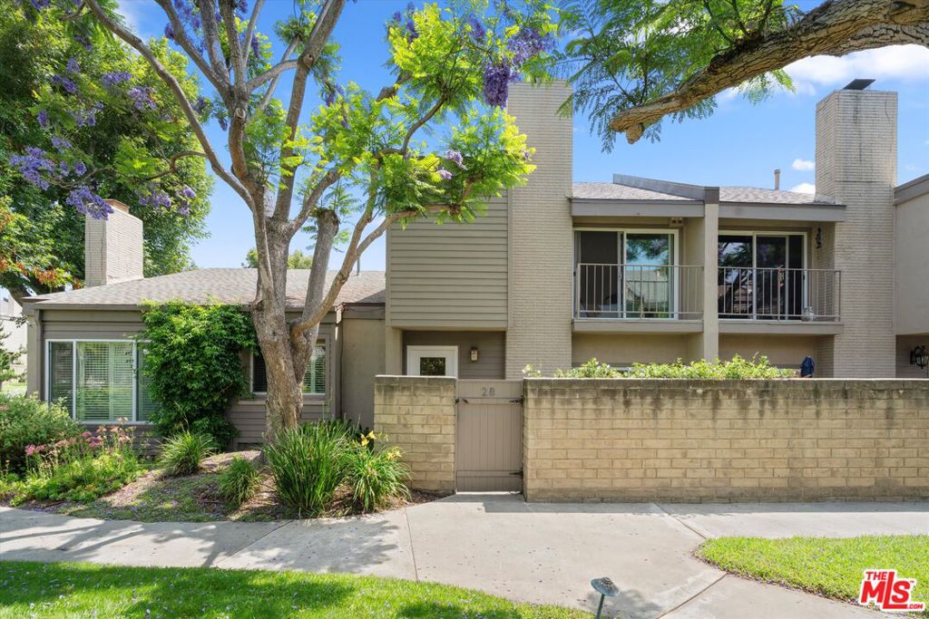 A quiet oasis in the heart of Sunset Park, Village Park Townhomes offers a living experience unlike any other in Santa Monica. The verdant grounds of this community cover 8 1/2 acres, with rolling green spaces, an abundance of trees and flowering plants, and amenities including a tennis court, community room, pool, spa, and sauna. Unit 28 is located just beyond the pool and great lawn, with treetop views from the private, gated patio out front. Entering the home you are greeted with modern oak engineered wood floors, a decorative stone fire place in the living room, an open dining room, and built in wine bar, with powder room nearby. Visible from the dining room sliding glass doors and the kitchen's picture window is an interior atrium patio, filling the space with light. White tile and stainless appliances brighten the kitchen, which connects to the spacious private two car garage with sparkling epoxy floor and finished walls, and ample space for storage. There you'll find new LG washer and dryer, as well as an additional fridge/freezer. Venture upstairs to find the bedrooms. The primary suite hosts a balcony looking out to the trees and garden, custom walk-in closet, modern double-sink vanity and en suite bath. The second bedroom, also with en suite shower-stall bathroom and separate, updated vanity area, is located cleverly to afford a sense of privacy. HOA dues include water, trash, basic cable and internet, and maintenance of the lush grounds. Blocks away from highly rated schools, shopping, dining, libraries, parks, and weekly farmers markets. Don't miss the opportunity to make this special place your home.