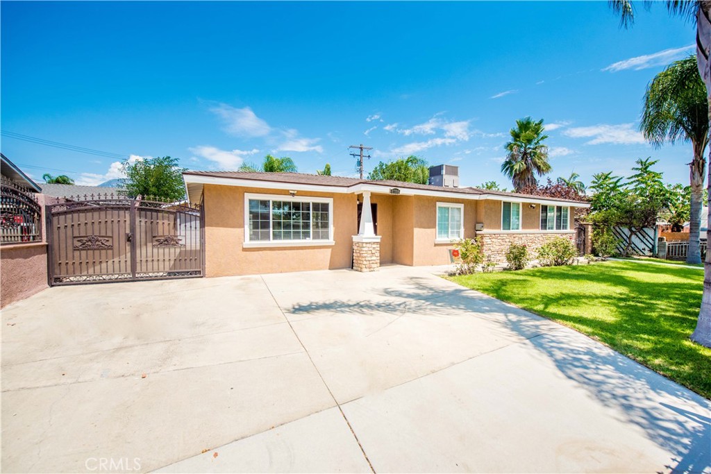 Looking for a turnkey home? This immaculate property is truly move-in ready. It offers a desirable open floor plan with a spacious living and dining area, complemented by laminate flooring and recessed lighting throughout. The gourmet kitchen boasts abundant cabinetry, granite countertops, and a stunning backsplash. The home features 4 bedrooms and 2 bathrooms, including a master suite with a walk-in closet. Additional updates include central air and heat, a newer roof, and a patio cover—all installed just 5 years ago. A block wall fence surrounds the property for added privacy. Bonus: The garage has been converted into a 2-bedroom, 1-bathroom ADU, complete with tile flooring and a wall-mounted A/C unit. The large, well-maintained yard is beautifully landscaped with mature trees, offering RV access and plenty of space for family gatherings and outdoor entertaining. This home is a must see.