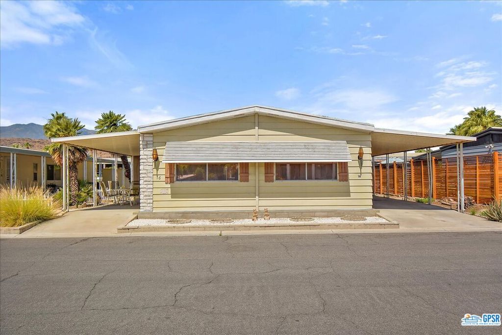 Welcome Home to Beautiful Palm Springs View Estates! This large home is in a wonderful quiet location in the community, close to pools and greenbelt walking areas. The layout of this home is very open and inviting with three large tinted windows in your front living area that gives wonderful morning light and makes the room light and bright. Your kitchen is open and original with lots of storage including a pantry and a breakfast bar for casual dining. There is a separate dining area that has additional storage and glass cabinets for showcasing your favorite collection and a window for natural light. There is a large open space off of the kitchen with a slider that leads to your completely screened in porch. This large room off the kitchen can be used as an office, a den, an informal living area, or whatever strikes your fancy. The large primary bedroom suite has wall length mirrored closets with lights inside and a separate linen closet. The primary bath has a spacious remodeled walk in shower and another large mirrored closet. Your second bedroom has a walk in closet, a large window and direct access to the second bathroom which makes it a second suite. The full size laundry area is located in the hallway with direct access to your carport. The laundry area has cabinets above and a broom/utility closet. The home has newer flooring throughout, a mix of laminate wood and tile. A wonderful addition to this home is the attached Arizona room. It is almost the length of the home and is completely screened in with a locked front and back entrance. The room is completely shaded with roll up blinds. On the carport side you have a large storage shed and room for an additional private patio area if desired. Palm Springs View Estates is a hidden gem in South PS. Rent controlled and 55+, there are three pools and spas, a clubhouse with gym, billiards room, and a large, comfortable meeting/lounging area. It is a very friendly community that is close to shopping, restaurants, and local entertainment. Come take a look at this beautiful home and community and see for yourself.