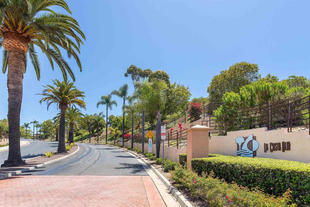 Your Gateway to the Carlsbad Lifestyle. Welcome to this beautifully upgraded corner unit home, tucked inside the vibrant, highly desirable La Costa—one of Carlsbad’s most sought-after neighborhoods. With peekaboo ocean views from your front door and cool coastal breezes, this home perfectly captures the charm of SoCal living. Step inside to find a light and bright open floor plan featuring luxury vinyl plank flooring, recessed lighting, newer windows, a modern fireplace with Quartz surround, and quick access to your patio for some fresh outdoor breeze. The renovated kitchen is a showstopper with sleek Quartz countertops and backsplash, fresh white cabinets, and stainless steel appliances. Enjoy casual meals at the breakfast bar, or take it outside for effortless al fresco dining on your patio—a perfect place for morning coffee and barbecues. The primary suite offers patio access, dual closets, and a stunning, fully remodeled master bathroom. A thoughtfully placed second bedroom sits on the opposite side of the home for added privacy. The guest bathroom has also been tastefully refreshed with a new vanity top, shower door, and refinished shower. You’ll also appreciate the convenience of an in-unit laundry (with newer washer & dryer included), a garage, additional parking space, and a dedicated storage room. Living here means access to resort-style amenities including an expansive pool, spa, and fitness center. You’re minutes from Carlsbad’s beaches, community parks, plethora of shopping, hiking trails like Batiquitos Lagoon, and world-class destinations like Omni La Costa Resort & Golf. Top-rated schools and convenient access to Palomar Airport make for a complete package. Whether you desire the beach, fun activities, or exploring the coastline, this home offers the perfect blend of location, amenities, and an active lifestyle. Crafted with care, designed for everyday luxury—live where others vacation.