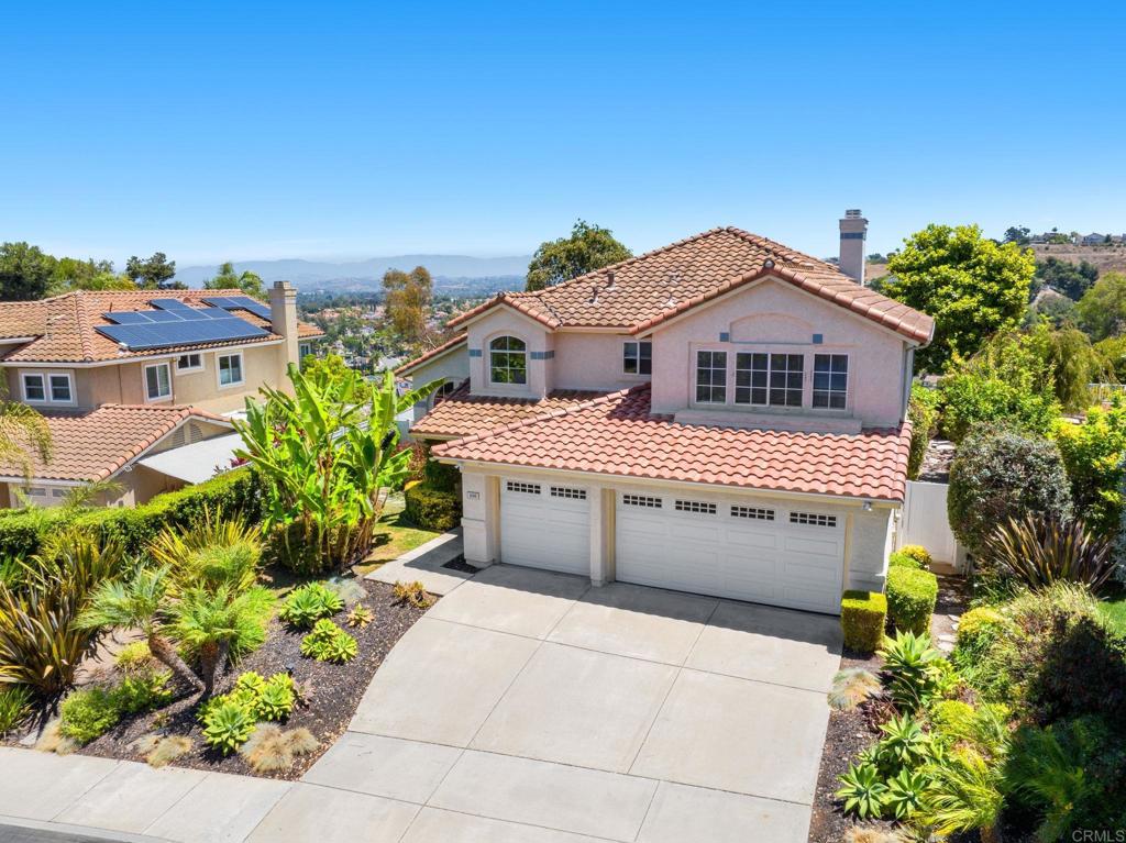 You won't want to miss this elegant home located in Rancho Del Oro Master's Community! Location! Location! Perched high on top of Masterpiece Drive with no homes behind, this large 5-bedroom, 3-bath home (2,704 sq. ft.) offers sweeping eastern views of greenery to the majestic mountains, twinkling evening lights and snow-capped peaks in the winter. Privacy abounds, with a steady coastal breeze, enhanced by lush landscaping and classic white vinyl fencing surrounding the property. Inside, the spacious granite kitchen features plenty of cabinet space, a large garden window to take in the view, a refrigerator, microwave, oven, gas cooktop and a large walk-in pantry. The adjacent family room opens through French doors to a serene private yard perfect for relaxing or entertaining. The thoughtfully designed floor plan includes a downstairs bedroom and full bath, ideal for guests or multi-generational living. Upstairs, the master suite offers French doors to an upper deck where you can savor forever views. An interior laundry room, abundant storage, an exterior built in storage shed and a three-car garage add convenience to the beauty of this property. This home seamlessly blends comfort, elegance, and unobstructed scenery.
