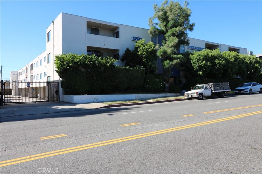 Spacious 2 BR/2 BA top floor corner condo facing Coldwater Canyon Avenue and located within Sutton Terrace North. Plenty of natural light fills this end unit located within a classic 1960's building in the Valley Glen area of North Hollywood. Double door entry, open floor plan with spacious living room, dining area adjacent to kitchen, vinyl floors, and newer carpet in bedrooms. Stylish galley kitchen w/tile floor, solid surface countertops, glass tile backsplash, and white appliances including Bosch dishwasher, gas cooktop range, and Frigidaire built-in oven. Large primary suite w/walk-in closet, bathroom w/double sinks and newly tiled stall shower, large covered balcony accessible from living room, kitchen and second bedroom w/views facing east. Other highlights include central air and heat, ceiling fans, newer window blinds, main lobby w/secured glass door entry, a community pool, and common laundry room on each floor. One assigned carport parking space w/gated entrance. Landlord pays monthly HOA dues which includes water and trash.