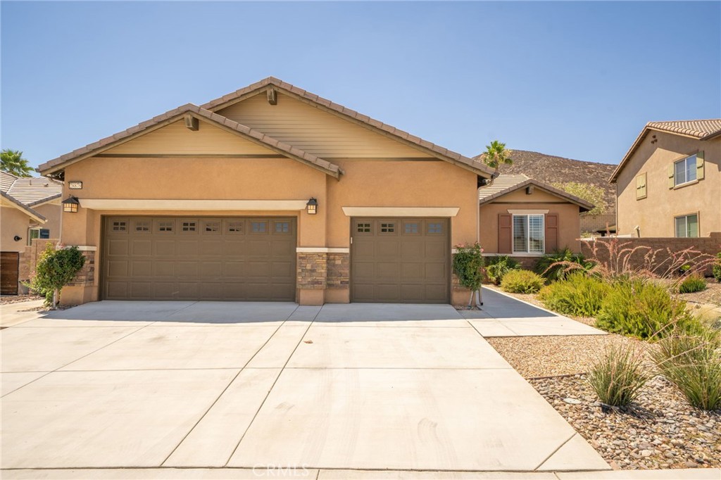 Welcome to this beautifully maintained home located in the highly sought-after Menifee Hills community! Nestled at the end of a peaceful cul-de-sac, this stunning residence showcases true pride of ownership inside and out. Enjoy drought-tolerant landscaping in both the front and back yards, providing curb appeal with low maintenance. Step inside to find wood laminate flooring throughout the main living areas, plush carpet in the bedrooms, and elegant plantation wood shutters throughout the home. The flexible front room makes a perfect den or office space. The open-concept layout features a spacious living room with a cozy gas fireplace, ceiling fans throughout to help keep energy costs down, and a dining area with direct access to the backyard. The kitchen is a chef’s dream, offering granite countertops, a large island with breakfast bar, stainless steel appliances including a 5-burner stove and double oven, walk-in pantry, and ample cabinetry. Down the hall, you’ll find all the bedrooms, including the spacious primary suite with an additional retreat area which would be ideal for a home office, nursery, or optional 4th bedroom. The primary ensuite bath includes dual sinks, a separate tub and shower, humidity control, and a large walk-in closet. Two additional guest bedrooms are serviced by a well-appointed bathroom with dual sinks, humidity control, and a tub/shower combo. Additional features include an indoor laundry room, tankless water heater, and an impressive 3-car garage equipped with suspended storage racks, heavy-duty cabinets, and a built-in workbench with additional storage. This home also has solar panels for added energy efficiency. The backyard is a serene escape, complete with a full-length Alumawood patio cover featuring recessed lighting, a ceiling fan, and pull-down sunshades, perfect for unwinding at the end of the day. This home is in close proximity to schools, parks, trails, shopping, and restaurants.