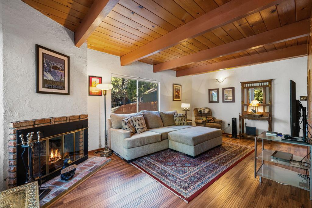 **One of the few cabins with central heat and air** Nestled among the serene pines of Idyllwild, this charming 2-bedroom, 2-bathroom cabin offers the perfect blend of rustic charm and modern comfort. The spacious front porch is an ideal spot for soaking in the outdoors, whether you're enjoying a morning coffee or watching the occasional deer pass by. Located just a short distance from downtown Idyllwild, this delightful cabin invites you to experience a tranquil mountain lifestyle. The living room, complete with a wood-burning fireplace, sets the scene for holiday gatherings and chilly evenings, creating a warm and inviting atmosphere. The open-concept kitchen is thoughtfully designed, providing extra space for all your visitors. A stackable washer and dryer add convenience to this well-appointed cabin. Step outside to discover a generous-sized, partially fenced backyard with a small platform deck--an open canvas for your creative ideas. Whether you envision a garden, a play area, or a quiet retreat, this space is ready for your personal touch. For nature lovers, the location is unbeatable. A short walk takes you to the Ernie Maxwell Scenic Trail and other nearby trails, perfect for hiking and exploring the natural beauty of Idyllwild. Motivated seller!