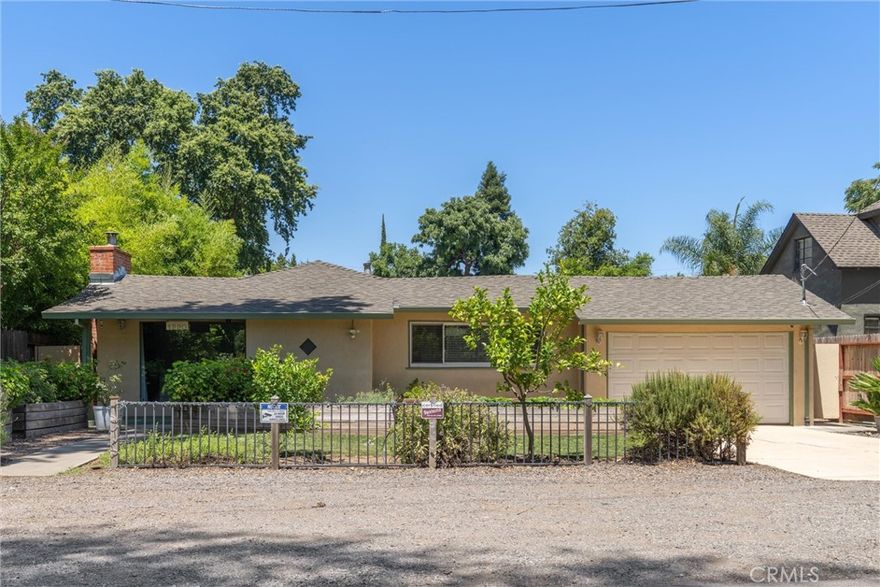 Have you been looking for a super charming home in a fabulous location on a HUGE lot for under $500,000. How about under $450,000?!  You'll want to get over to see this gem ASAP! This darling 3-bedroom 2 bath home sits on a lovely 1/3-acre lot with great alley access (through a massive entry gate suitable for toys, trucks etc.). The living, kitchen and dining area all look across the quiet country lane to a lush wall of green... and Big Chico Creek. This is 'close-in country living' at its best! The charm starts at the wrought iron fence and continues down the path to the covered front porch, darling entry alcove and into the living area with it's hardwood flooring, brick fireplace, built-ins and a large picture window. The kitchen is very functional and open to the dining area. And, though it's older, it would be an easy facelift! Two of the 3 bedrooms were extended and are extra-large. There's an interior laundry room, lots of storage... and both bathrooms have updates.  PLUS, new dual pane windows, H/A ducting, new grounded plugs, upgraded insulation and many more practical features! Even with all this the star of the show might just be the awesome fully fenced lot with room for an ADU, shop, giant garden, you name it. It already has a fruit orchard and a shade structure with drip lines installed. The potential is limitless!