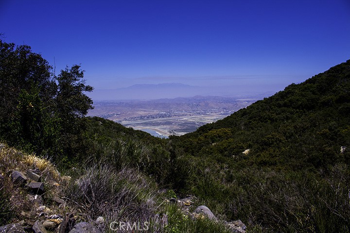 HERE'S YOUR CHANCE TO BUILD YOUR LITTLE SLICE OF HEAVEN on this BEAUTIFUL PANORAMIC VIEW LOT high above Lake Elsinore in the historic equestrian community of Rancho Capistrano! Just 5 scenic miles off of Ortega Hwy (HWY 74), in Cleveland National Forest, this community is perfect for Equestrians, Commuting executives, Growing families, or a Stunning Weekend Retreat! This lot is 2.55 acres, is ready to build, just outside the main gate entrance. A 2000-gallon septic tank and water meter are already on site. Seller already has some initial planning completed. Renderings available. Riding trails, hiking trails, and wildlife abound within and around the naturally beautiful community. Association amenities include a Clubhouse, Tennis courts, newly paved "horse friendly" streets throughout the gated area. Community gatherings and neighborly actions are "the norm" here. Close to I-15, lake access, shopping and schools and only 30 minutes from San Juan Capistrano, this lot is not to be missed!