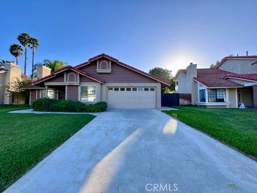 Welcome to this stunning single story home in Rainbow Canyon, nestled in the heart of Temecula! This beautifully maintained home features 4 spacious bedrooms and 2 upgraded bathrooms, and truly shows like a model home. Enter inside to find upgraded plank flooring, a neutral paint scheme, and a thoughtful layout with modern touches throughout. The inviting living room boasts a cozy fireplace and large windows that let in plenty of natural light. The adjacent kitchen overlooks the backyard and dining area, and features quartz countertops, a deep sink, stainless steel appliances (including a refrigerator), and ample cabinetry for extra storage. Down the hallway, you’ll find all bedrooms, both bathrooms, and the laundry room. Each bedroom is generously sized. The hall bathroom includes a shower/tub combo, while the primary suite is a true retreat, featuring two oversized closets, a sliding door leading to the backyard, and an ensuite bathroom with dual sinks and a spa like walk-in shower. The backyard is beautiful with two covered patio areas, lush green grass, and mature trees providing privacy. Don’t miss your opportunity to rent this beautiful, move-in-ready home in one of Temecula’s most desirable communities!