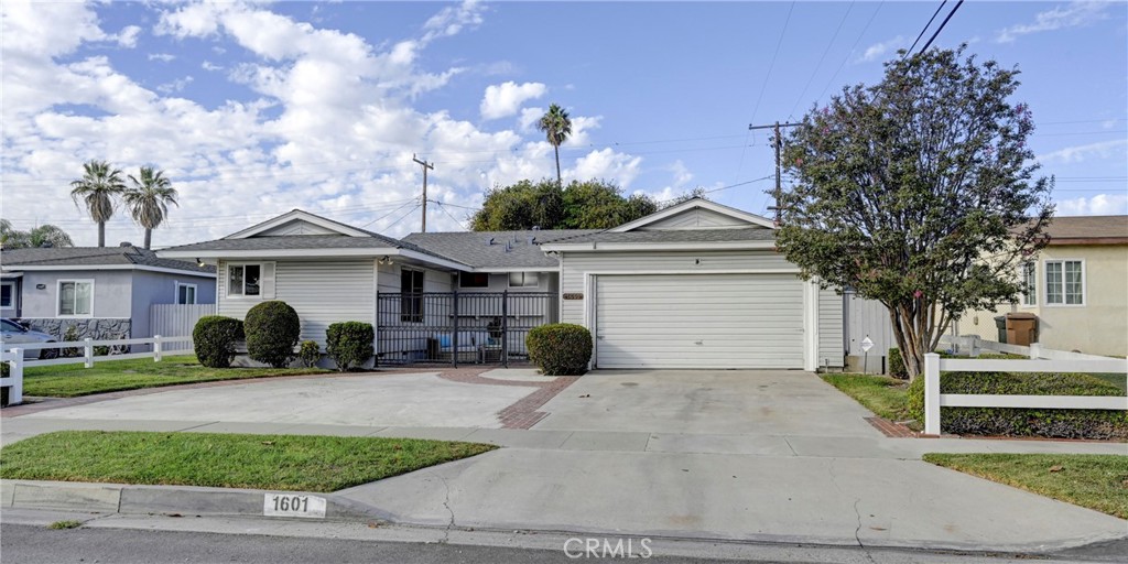Welcome to this charming Mid-Century single-story home on a beautiful interior street in a pride-of-ownership Fullerton neighborhood. Curb appeal shines with a curved driveway that fits six cars, mature landscaping, and a private, gated brick porch perfect for relaxing outdoors. Inside, the bright living room features original hardwood floors, a cozy brick fireplace, and timeless character. Offering over 2,200 sq. ft. of living space on a 6,900+ sq. ft. lot, this home blends space and comfort. The open layout flows from the living and dining areas to a spacious step-down family room with vaulted wood-beamed ceilings, built-in bar and BBQ, and sliding doors to the backyard. The vintage kitchen, with preserved tile counters and double ovens, has direct garage access. Down the hall are four comfortable bedrooms and two bathrooms. The two-car garage includes storage, a utility sink, washer/dryer hookups, and water softener. Additional highlights include central heat, brand-new A/C, attic fan, in-home safe, built-in hampers, heaters in both bathrooms, outdoor flood lights, and freshly painted interior. Ideally located near schools, parks, freeways, and downtown Fullerton’s dining and shopping, this home offers space, function, and convenience—all under $1 million.