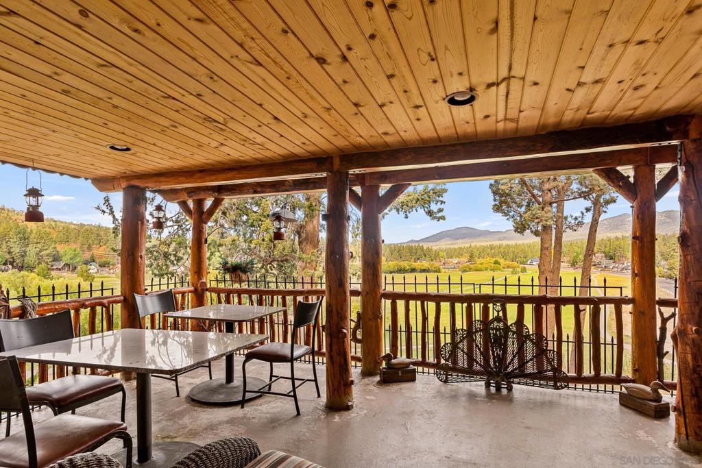 Beautiful log home with an amazing view to the west, located on the 4th T of the Big Bear Golf Course.. This home was built in 1954, much of the home was hand crafted in the very garage it has now.. Then in 2006, the home was given a new life with more of today's amenenties. It is one of the most unique homes you will see in Big Bear today. Main level has one bedroom and bath, living room,dining room and kitchen. Top level has 2 bedrooms with one bath.. With a small adjustment, a 3rd bedroom can be achieved. The lower level bedroom has a full bath, claw foot tub, gas free standing stove, and a small kitchenette. With a little addition to that room, it could be used as a separate livable space. VRBO history for one year, this year will be better. The owners have added many ameneties, including heat and air split units on all levels. Free standing gas fireplace in the lower bedroom/basement aread, 90% of the windows are new dual pane, new large hot water heater, new spa as of 2024 located outside the front door. The lot is oversized with large wood decks on both sides of the home.. Commerial lighting lights up the large trees at night. Part of the roof was replaced and the roof is in good condition. New dishwasher as of 2023. New metal and glass door leads into the mudroom with combo lock. The garage has also been crafted with wood doors and elk handles on all of them. Plenty of storage in the garage and in the attic above the garage. Both refrigerators, kitchen and garage stay.. Garage door has auto opener. 2 additional concrete parking spaces were added so 4 cars fit comfortably on the property. The lighting fixture above the dining table and the one in the upstairs hallway are works of art.. This is a unique, old school big bear cabin. And, your kids can sled right outside the back door onto the golf course. It's fun to watch the golfers too.
