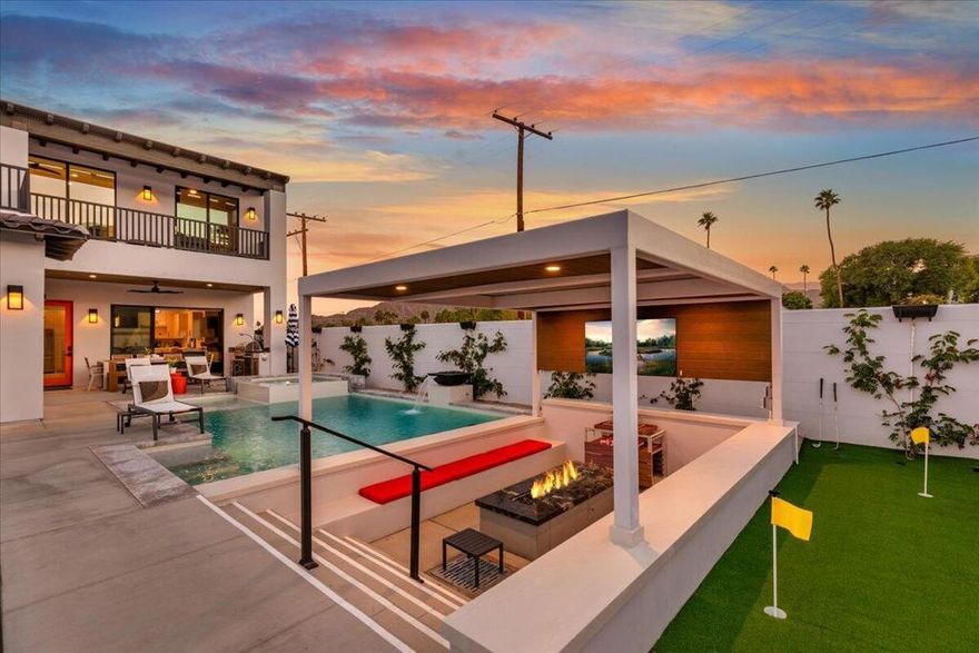 Escape to this modern desert oasis featuring 4 ensuite bedrooms including dual masters, a resort-style pool with swim-up bar, sunken firepit lounge with TV, BBQ area, and putting green. Enjoy high ceilings, quartz finishes, and seamless indoor-outdoor living with mountain views. Perfect for families or groups seeking luxury, relaxation, and entertainment in a private gated retreat.This property is new construction and the photos are mock ups from the architect. Actual photos of home to follow.