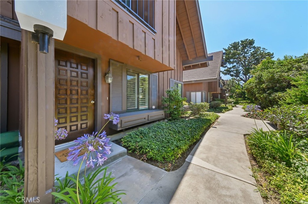 Welcome to your own little oasis in The Gardens; a peaceful, tucked away corner end unit that feels like a true retreat from the busy city. This charming townhome offers 1,572 square feet of warm and inviting space, featuring new luxury vinyl on the first level, newer dual pane windows and sliding doors, and plantation shutters throughout to keep things comfortable and quiet inside. The living room is bright and roomy, with a separate dining area, a powder room, and a flexible family space that flows right into the kitchen. The kitchen is equipped with granite counters, stainless steel appliances, and ample cabinetry, everything you need to whip up a quick meal or entertain with ease. Upstairs, you'll find two spacious primary bedrooms, each with its own bright and airy en-suite, perfect for relaxing and recharging in total privacy. Step outside to your own private patio, ideal for morning coffee, evening wine, or simply enjoying some quiet time. Since this unit backs up to the rear of the complex, you’ll also enjoy added privacy and convenient guest parking. Surrounded by tree lined paths, and you’ll also have access to tennis courts, a sparkling pool, and a community center. Close to shopping, restaurants, and the 110 Freeway are just minutes away. Don't miss this one!