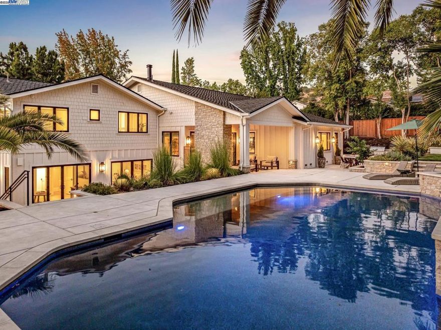 Experience this meticulously expanded & renovated masterpiece in Alamo's coveted Roundhill community. Designed by William Wood, this home redefines modern luxury with masterful design & impeccable high-end finishes. The heart of the home is a spectacular great room w/soaring ceilings, wide-plank white oak flooring, & a custom stone fireplace with direct access to the backyard. It seamlessly integrates a culinary dream kitchen, anchored by an expansive Calcutta marble island & equipped with a Wolf Range, Sub-Zero refrigerator, wine refrigerator, & custom solid wood cabinetry. The primary suite is a private sanctuary w/fireplace, an oversized "showcase" walk-in closet, & a spacious marble ensuite bath w/heated floors. Three of four guest bedrooms are also ensuite. A well-appointed office w/custom built-ins provides the perfect workspace. The home features top-of-the-line Andersen E-Series windows & doors throughout. Effortless living is achieved via a state-of-the-art smart home w/Josh.ai voice control, Lutron lighting, & automated shades. Relish in the resort-like yard, featuring a covered pavilion w/a fireplace & heaters, an outdoor kitchen, a PebbleTec pool w/baja shelf, a putting green, & a sport court. A rare opportunity to own a luxurious turnkey estate in a premier location.