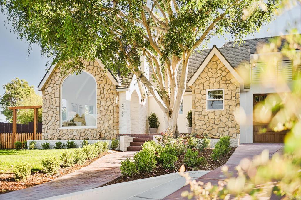 Welcome to 3951 Atascadero Drive, a beautifully reimagined Tudor residence in Point Loma offering 2,794 sq. ft. of timeless charm and modern comfort. Distinguished by its striking roof lines, this two-story home has been fully redone from top to bottom with thoughtful upgrades including all-new windows, HVAC, roof, engineered hardwood flooring, upgraded electrical, and upgraded plumbing. The inviting floor plan features four spacious bedrooms and three full bathrooms, including a downstairs primary suite with an oversized double shower that feels like a private retreat. The heart of the home is the entertainer’s kitchen, highlighted by warm wood ceilings, sleek finishes, and a seamless flow into the dining and living spaces. Natural light fills the home, creating an airy, open feel that enhances both everyday living and special gatherings. A charming oversized laundry room adds convenience while reflecting the home’s attention to detail. Upstairs, two additional bedrooms and a versatile loft/game room provide flexible living options for family, guests, or a home office. The upstairs deck is the perfect spot to unwind, offering refreshing coastal breezes and views toward the surrounding neighborhood and SeaWorld in the distance — where summer evenings are illuminated by seasonal fireworks. Equally impressive outdoors, the home features a stone façade and an entertainer’s backyard designed for gatherings. A large pergola with built-in bench seating and an outdoor fireplace creates the perfect setting for evenings with friends and family under the San Diego sky. Located in one of Point Loma’s most walkable and sought-after communities, this home combines historic charm with modern design. Stroll to neighborhood cafés, enjoy dining and entertainment at Liberty Station, or take in breathtaking sunsets at nearby Sunset Cliffs. Local beaches, downtown San Diego, and the airport are just minutes away, making this an ideal location for convenience and lifestyle. Families will also appreciate access to highly rated schools including Silver Gate Elementary, Dana Middle, and Point Loma High. From rich neighborhood history to upgraded interiors, a stunning backyard, and coastal living, 3951 Atascadero offers a rare blend of elegance, comfort, and location that truly has it all.