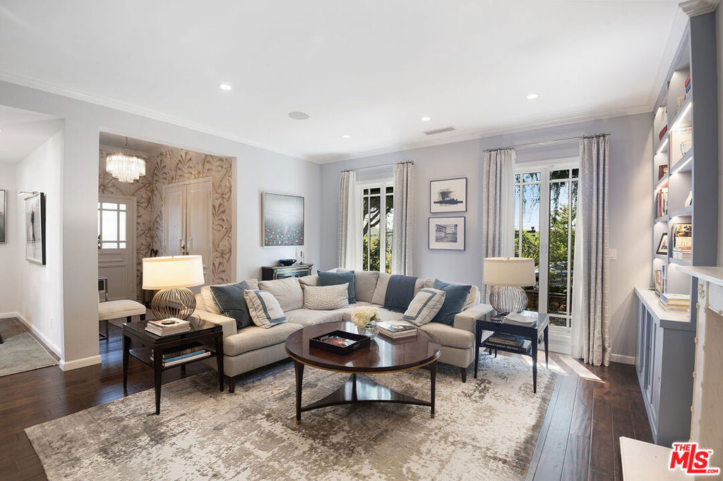 Tucked away in the heart of the coveted Norma Triangle, this enchanting Hollywood Regency home blends timeless elegance with the relaxed charm of modern Los Angeles living. The residence features a spacious living room with soaring ceilings, a statuary marble fireplace, custom built-ins with dimmable lighting, and rich hardwood floors. Designed for both entertaining and everyday comfort, the gourmet kitchen showcases a Wolf oven and microwave, a six-burner Wolf cooktop, an integrated Subzero refrigerator, a 160-bottle wine refrigerator, quartzite countertops, a stainless steel farm sink with garbage disposal, Heath Ceramics backsplash, and custom solid wood Shaker-style cabinetry including a large pantry cabinet, all enhanced by in-ceiling wireless speakers. With 2 bedrooms, 2 baths, and a bonus room with a separate entrance perfect for a home office, creative studio, or personal gym the home offers flexible living options. The primary suite boasts custom cabinetry closets with lighting, hampers, and shoe storage, while the spa-like bathroom includes a walk-in rain shower with Heath Ceramics tile and bench, a lighted niche, custom vanity, a window, and a Kohler Japanese-style smart toilet. The guest bath features marble tile, a soaking tub with lighted niche, and a windowed layout for natural light. Additional highlights include custom silk curtains, a built-in desk with cabinetry and dimmable lighting, in-ceiling wireless speakers throughout, and a front patio with built-in seating and custom cushions. Outdoors, a heated pool creates a private oasis, while the home's security is elevated with a transferable SimpliSafe system. Beyond the property, the Norma Triangle neighborhood is home to some of Los Angeles' most vibrant nightlife and lifestyle amenities, including world-famous venues like The Abbey, Stash, and Bottega Louie, as well as Sunset Strip icons such as the Viper Room and the Rainbow Bar & Grill. Trendy boutiques, upscale shopping on Melrose Avenue, and fitness centers like Equinox are all just moments away, placing the very best of West Hollywood living right at your doorstep. Contact listing agent directly. This will lease quick!