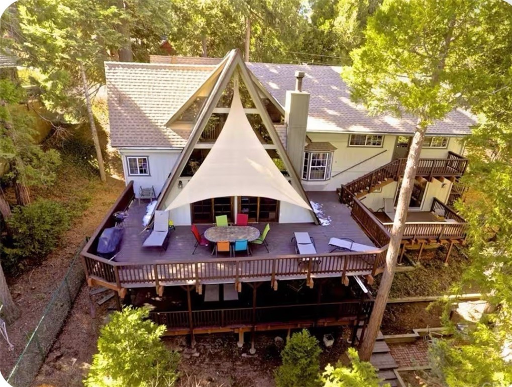 SOOO CHARMING!!! SO RUSTIC!!! You Will Love this Amazing A-FRAME Just Oozing with Character that Has 4 Bedrooms, 3 Baths AND a Separate Apartment for Family or Friends! The WALL OF WINDOWS Brings in Just the Right Amount of Natural Light Against the Sprawling Wood Walls! The Living Room is Sooo Cozy & Just Perfect to Cuddle up with a Book, Close to a Warm Fire to Watch the Snow Fall! The Kitchen is Well-Equipped with Plenty of Storage and You Have a Full-Size Dining Table to Celebrate Thanksgiving and Other Holidays with Lots of Family & Friends! THE SUPER DEEP DECKS are Soooo Great!!!! Sit Amongst the Many Tall Cedars & Pines, Lounge in the Hammock and Enjoy Peace of Mind Knowing the Kids and Pups are Safe Playing in the HUGE FENCED YARD. On the Main Level are 2 Bedrooms and a Bath. Upstairs is a Wonderful Primary Bedroom with Tall A-Frame Ceilings, a Huge Walk-in Closet, a Private Deck and Fireplace! Enjoy a Bubble Bath in the Tub on Your Weekend Getaway or Play a Game of Pool in the Game Room in the Adjoining Loft! There is Even the CUTEST Tucked Away Bedroom with Toys Galore for the Little One!! Downstairs is a Private Suite!!! Bedroom with Living Room, Complete with Fireplace, Private Bath & Deck! WOW!! And there is Still a Separate Studio Apartment on the Other Side of Home! Perfect for Extended Family or to Offset Your Mortgage with Extra Income! The Oversized Studio is Sooo Adorable w/Sleeping Area Tucked in the Back, Walk-in-Closet, Comfy Living Room, Kitchen & Bath. Modern Fireplace and Adorable Private Deck to Enjoy a Barbecue! So Nice to Have Totally Level Entry with Parking for 6, Plus the Garage when it's Snowing or You are Entertaining! And the Neighborhood is the BEST!!! Cul-de-sac Street with the Best Neighbors and a Short Walk to the Village and Lake!!! Great Commuter Location too!!! This is a Fantastic Home for Full-Time Living, a Second Home for a Large Family or Even to Short Term Rent! It Has Been a Successful Rental for Several Years! Income Available Upon Request!