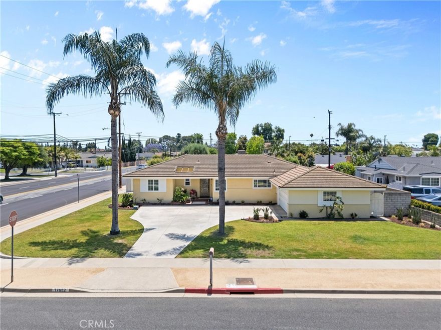 Welcome to this stunning pool home near North Tustin that awaits its next family! Pride of ownership is evident on this property everywhere! Offered for sale is this completely renovated 4-bedroom, 2 bathroom home on a HUGE 10,000 square foot lot! Enter through the wrought iron with glass insert front door to a travertine tiled foyer. The home has original hardwood floors stained in a lovely 2-toned mix of beige and espresso brown. The home boasts canned lighting throughout, extra tall baseboards and warm cream paint. Renovations include new kitchen with granite countertops, stainless steel appliances, oven, microwave, rich high-end cabinets and travertine tiled floors. The laundry room is off the kitchen and has a door to the side yard. The kitchen opens to the dining room and living room and has a granite bar with room for 4 stools. The spacious living room has a gas fireplace centered on a used brick facade and wood mantel, evoking a warm conversational feel. The master bedroom to the west side of the home has a 3/4 bath, beautifully remodeled with tiled walls, shower, floors and glass shower door and dual shower heads. On the east side of the home are 3 additional bedrooms, one of which has beadboard walls and rich blue paint. The full bath off the hall is exquisite boasting white marble tiles veined in gray and black 2/3 up the walls and veined subway tiles floor to ceiling in the bath/shower!  The shower has 2 shower heads, one with a handle for convenience and a large rain head fixture. All interior doors are newer solid core and there are custom plantation shutters on all windows and sliding glass door to the back yard.  No expense was spared in the thoughtful remodel of this home. Outside enjoy a section for storage and trash cans separated from another side yard with room for outdoor dining and barbequing... and yet another gate to the HUGE back yard! Central heat and AC, tankless water heater and updated electrical, too. Block wall fencing surrounds the yard for privacy, and the sparkling pool is ready for summer!  A detached 2 car garage sets behind a large curved driveway with room for several cars.  This cul-de-sac street is very family friendly! Don't miss out....room for ADU possible, check with city, and maybe even RV access if you get creative!  So much space...