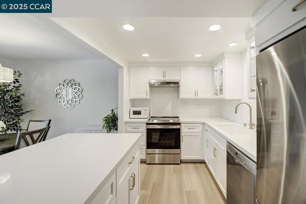 Charming Sonoma recently remodeled in the heart of Rossmoor features dual pane windows, smooth ceilings, modern kitchen, and luxury vinyl plank flooring throughout. The kitchen has been completely upgraded with beautiful quartz counters, recessed LED lighting, tiled backsplash, stainless appliances, and white shaker cabinets. Conveniently located at the end of the court with the carport close by. Large deck to enjoy the lovely weather and peaceful views of hills. Stacked washer/dryer located in bathroom. This home is completely turn key and ready to go!