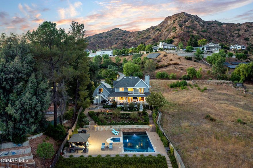 Welcome to 29728 Triunfo Dr., an exquisite property nestled in the heart of Agoura Hills and the Santa Monica Mountains. This stunning residence offers a perfect blend of luxury, comfort, and serene living, making it an ideal home for those seeking tranquility without sacrificing convenience. As you approach the property, you'll be captivated by its charming curb appeal, magnificent canyon views, lush landscaping and a grand entrance. Situated on more than half an acre, this spacious almost 4,300 square foot three story home boasts 6 bedrooms, and 3.5 bathrooms, providing ample space for family, guests and entertaining. Inside, you'll find a truly incredible floor plan with a sweeping staircase, high ceilings and large windows that flood the space with natural light and breathtaking canyon views. The gourmet kitchen is a chef's dream, equipped with top-of-the-line stainless steel appliances, custom cabinetry, and a large island perfect for entertaining. Adjacent to the kitchen is a cozy family room with a fireplace, creating a warm and inviting atmosphere. The primary suite is a true retreat, with access to a scenic balcony that overlooks the lush grounds of your flawless backyard, unobstructed views of the Santa Monica Mountain Range, two walk in closets, and completed with a luxurious en-suite spa inspired bathroom featuring a soaking tub, dual vanities, heated floors and a walk-in steam shower. Additional bedrooms are generously sized and offer plenty of closet space providing family members or guests with their own haven of comfort and privacy. Step outside to your private backyard oasis. Immerse yourself in the enchanting surroundings as you lounge by the sparkling copper plumbed pool, unwind in the spa, or bask in the sun on the sprawling patio. Enjoy the wrap around porch for outdoor dining and relaxation. The meticulously landscaped yard provides a serene backdrop and ensures privacy. Located in the desirable community of Agoura Hills, this property is conveniently close to top-rated schools, shopping, dining, and recreational activities. Enjoy easy access to scenic hiking trails, parks, and the stunning beaches of Malibu.
