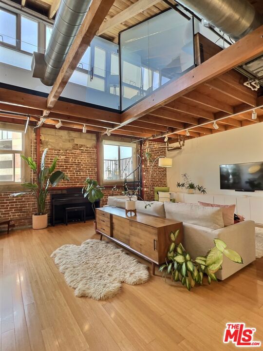 Rare two level character loft in the Molino Street Lofts with private patio and skyline views! Exposed brick, vaulted wood beamed ceilings, wood floors. Quality, uniqueness and charm abound! Situated in the center of the Arts District, a short distance to the many neighborhood restaurants, bars, coffee shops and boutiques; including Manuela at Hauser Wirth, SoHo Warehouse, Bavel, Bestia, Girl and The Goat, Kodo and Verve Coffee. Close to USC, SCI-Arc, Arts District dog park, and transportation. Come fall in love!