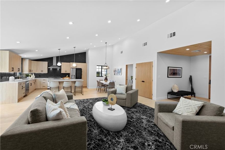 Nestled in highly sought after Encino Village, this home has been completely remodeled and offers 4 bedrooms and 3 bathrooms across nearly 1,750 sq. ft. of living space. Set on a quiet, tree-lined street where pride of ownership shines, it boasts inviting curb appeal and a thoughtfully designed open concept floor plan, perfect for entertaining and everyday living. The light-filled living room and kitchen create a warm, welcoming ambiance, enhanced by premium wood floors and recessed lighting. The chef's kitchen features new quartz countertops, a ceramic tile backsplash, custom cabinets, and brand-new stainless steel appliances and center island with a Breakfast/Buffet Bar. The spacious primary suite includes a stylish en suite bathroom and new slider access to a peaceful back yard while the additional bedrooms share a beautifully renovated bathroom. The 4th bedroom is separated and features its own bathroom, perfect for an office or in-laws. Green and Private Yard features a patio, lawn and mature foliage. An attached 2-car garage with opener offers excellent potential for conversion into a private guest suite, home office, or creative space. Additional updates include dual-pane windows, central air/heat, copper plumbing, modern fixtures. Walk to Park for Playground, Soccer, Baseball, Jogging, and Community Center. Take the Bike Paths to Scenic Lake Balboa. Just minutes to 101 and 405 Freeways, Shopping and Restaurants.  Award Winning Encino Elementary!
